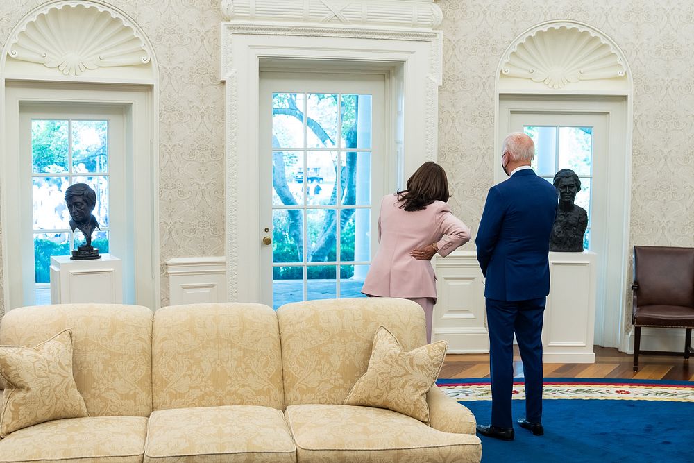 President Joe Biden and Vice President Kamala Harris look out the widows of the Oval Office of the White House, Thursday…