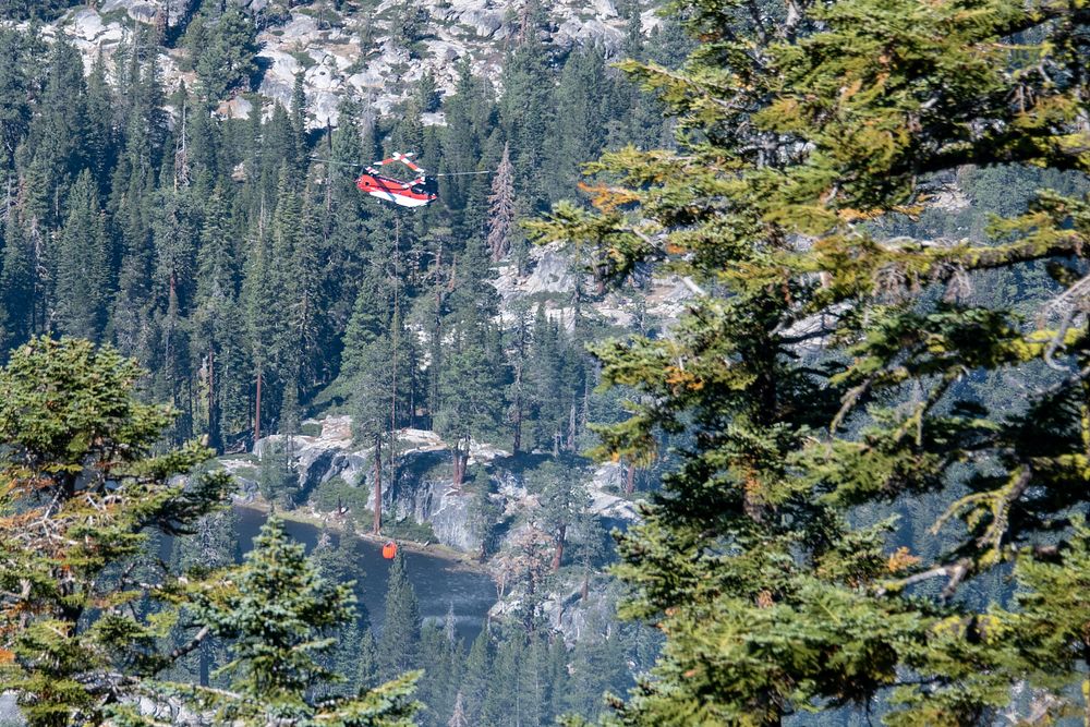Caldor Fire. Large helicopters drop water on the Caldor Fire in California. Photo by Joe Bradshaw, BLM. Original public…
