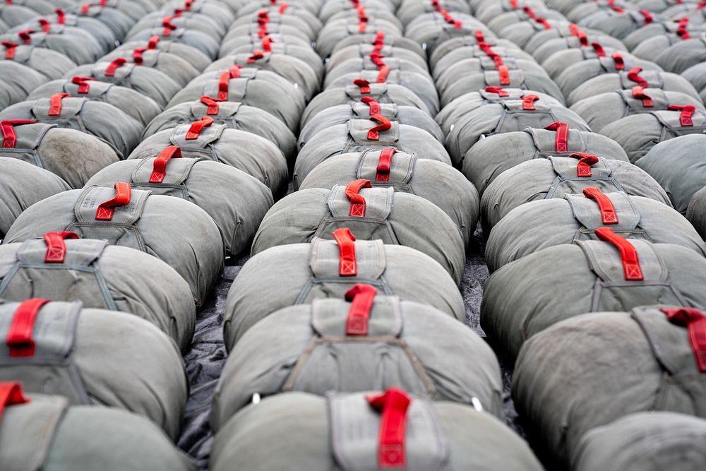 Reserve parachutes are returned after a successful jump by paratroopers assigned to the 4th Infantry Brigade Combat Team…