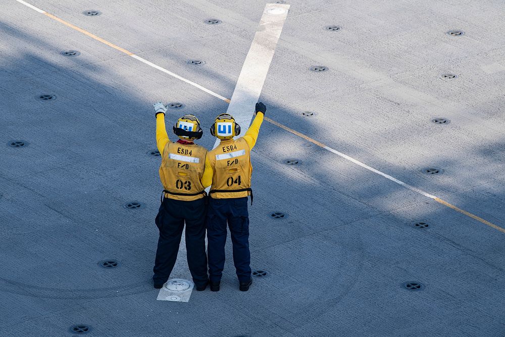 INDIAN OCEAN (Nov. 30, 2021) Sailors assigned to Air Department conduct landing signalman training during flight quarters…