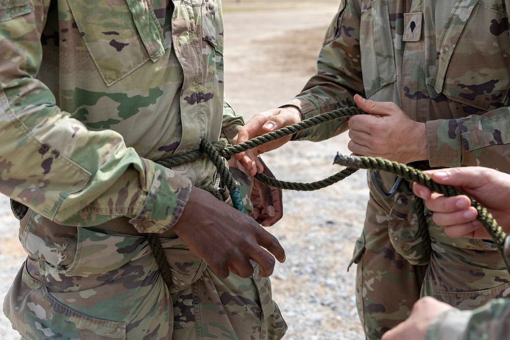 Soldiers completing the final phase of the Air Assault Course, the rappel phase, receive instruction on how to conduct…