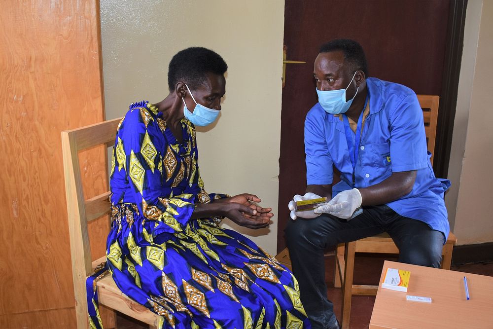 Community health worker, Venuste, tests a community member for malaria