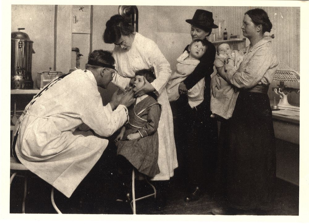 Well Baby Clinic, Red Cross Headquarters, New York. Abstract: Black and white reproduction of a c. 1918 photograph of the…
