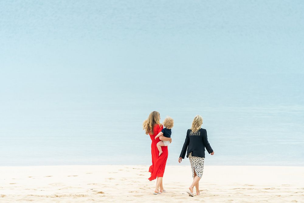 First Lady Jill Biden walks on the beach with Carrie Johnson, wife of British Prime Minister Boris Johnson, and her son…
