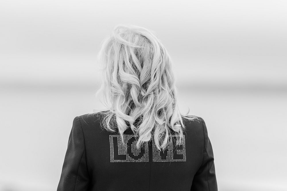 First Lady Jill Biden shows off the word “love” written on the back of her jacket during a press gaggle, Thursday, June 10…