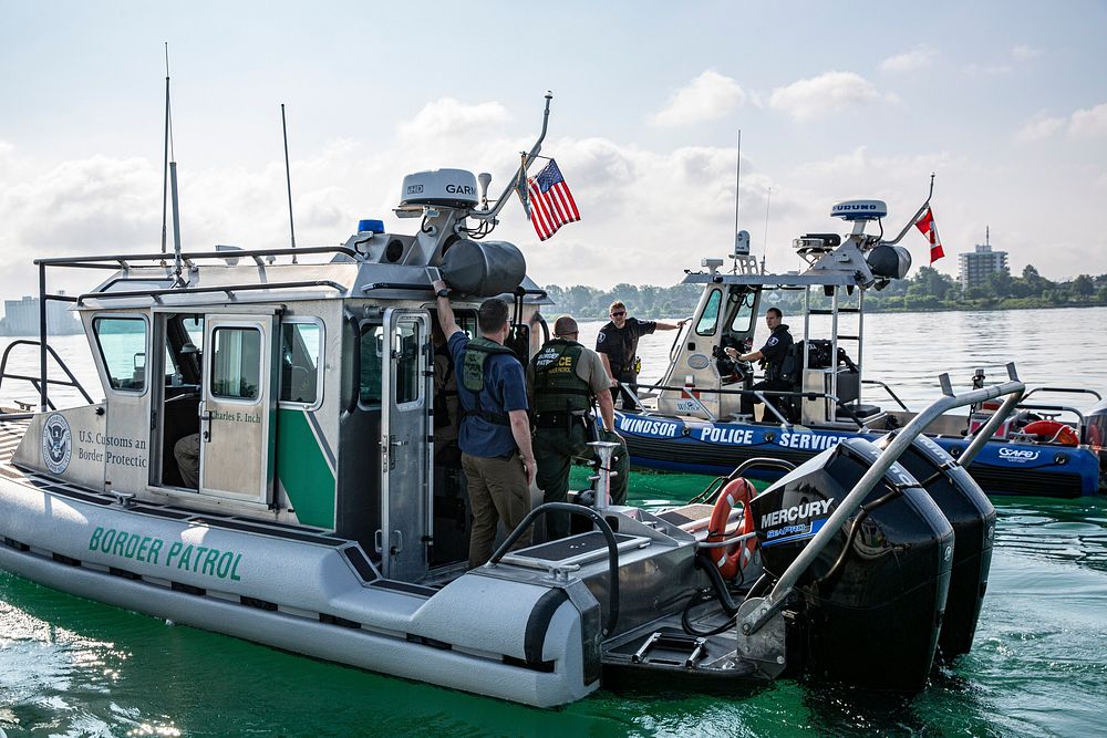 A Windsor Police SAFE boat pulls alongside a U.S. Border Patrol SAFE boat to discuss operations on the Detroit River, near…