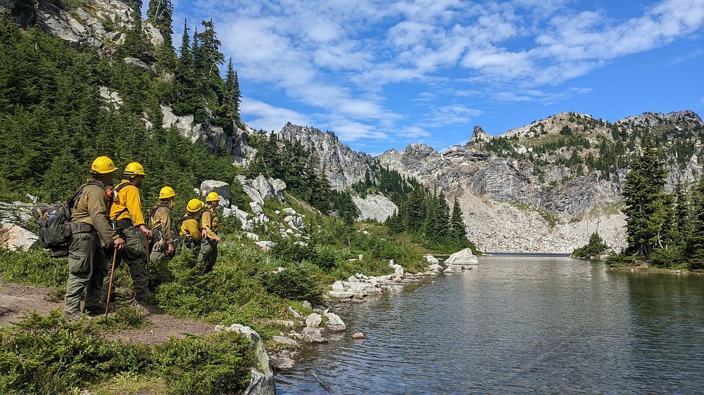 Firefighters contemplating WR IP Fires 220822A group of firefighters assess the scene during the White River and Irving Peak…