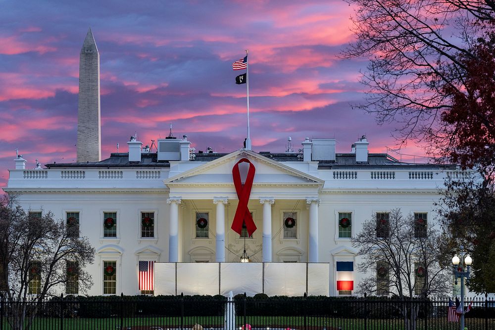 A red ribbon is seen in honor of World AIDS Day, Wednesday, November 30, 2022, on the North Portico of the White House.…