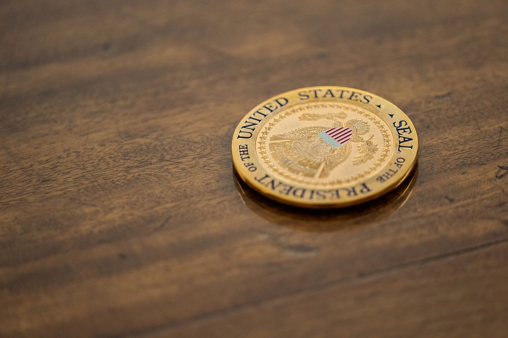 A coaster sits on a table in the Oval Office while President Joe Biden meets with White House staff Friday, October 21…