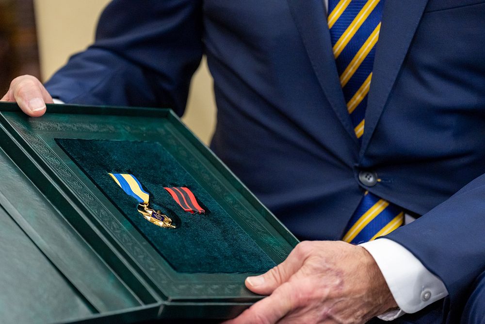 President Joe Biden is presented with The Cross for Military Merit during a meeting with Ukrainian President Volodymyr…