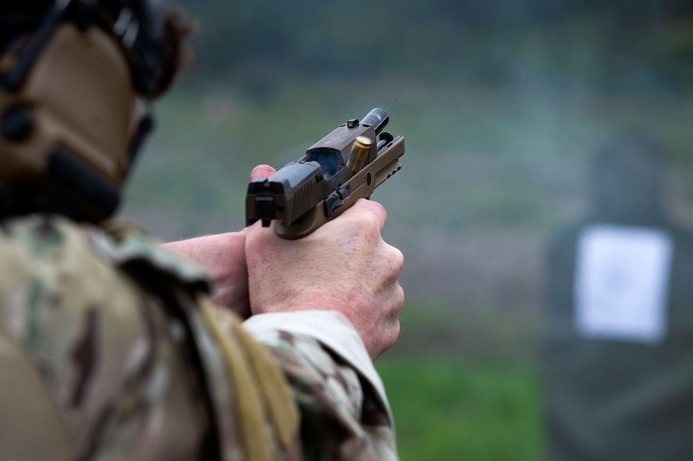 Soldier fires the M18 Modular Handgun System during small arms live-fire training.