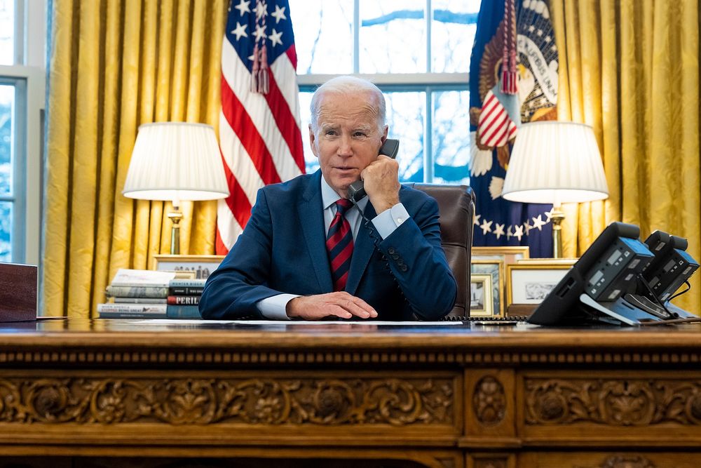 President Joe Biden talks on the phone with Brandon Tsay, Tuesday, January 24, 2023, in the Oval Office. Tsay disarmed the…