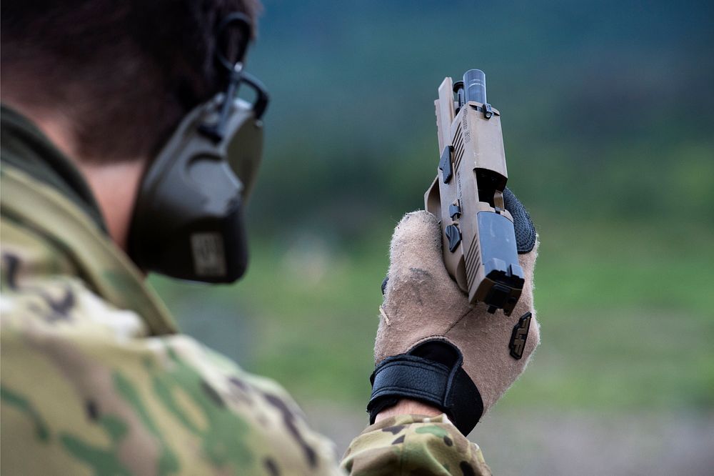 Soldier fires the M18 Modular Handgun System during small arms live-fire training.