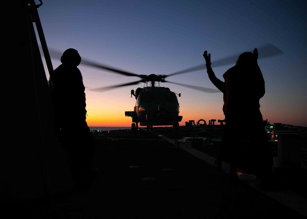  ATLANTIC OCEAN (Feb. 2, 2023) Sailors direct an MH-60S helicopter on the flight deck of the Arleigh Burke-class guided…