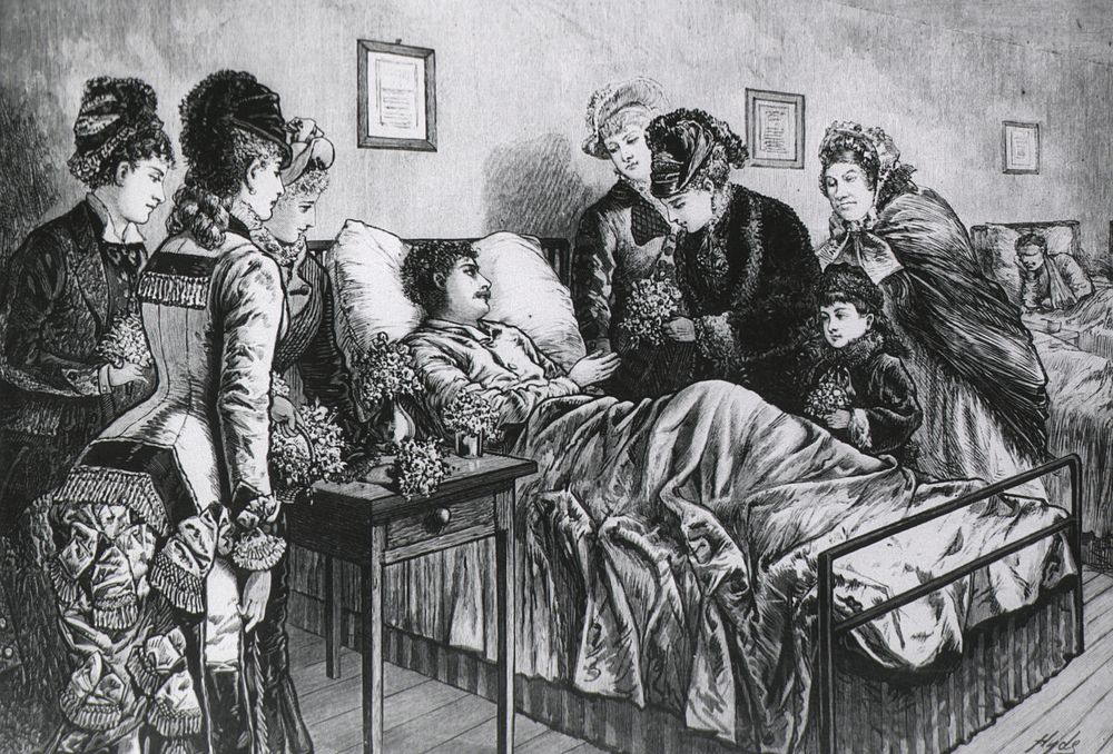Man in Hospital Receiving Flowers from a Group of Visitors.
