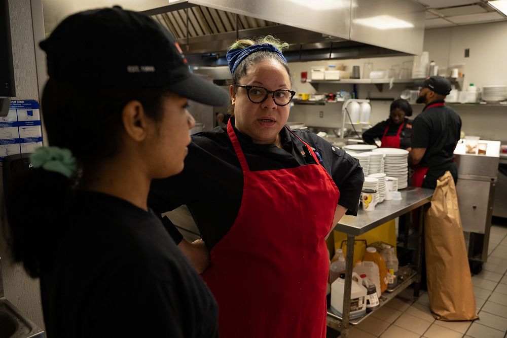 Chief culinary officer Martha Wiggins at Café Reconcile, right, mentors a trainee before the start of service in New…