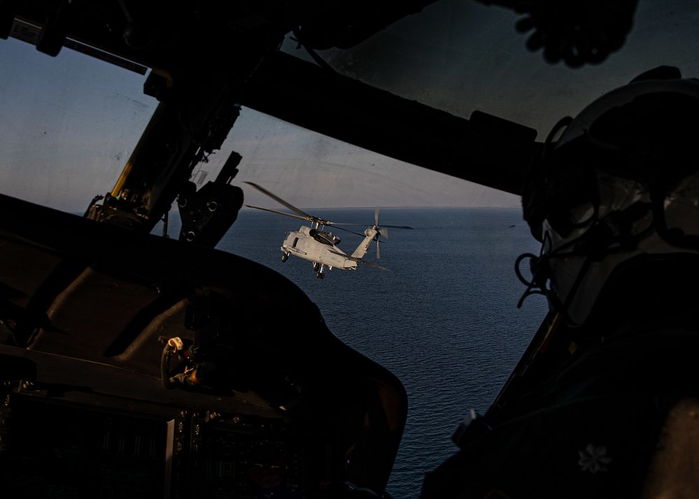  ADRIATIC SEA (Feb. 22, 2023) A Spanish SH-60B helicopter flies in front of an MH-60S Nighthawk helicopter, assigned to…