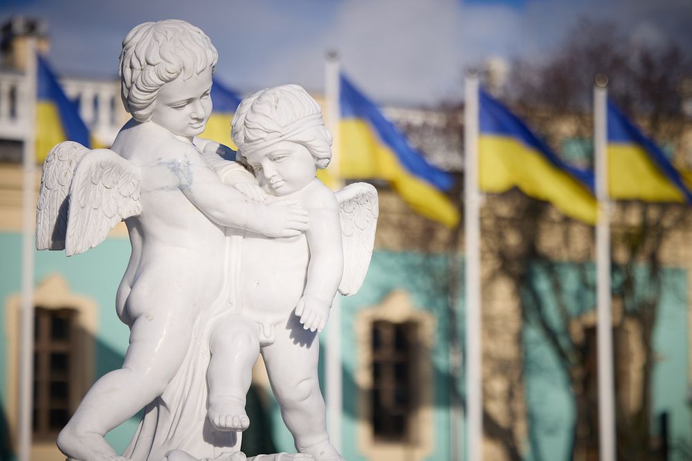 Cherubs statue with Ukrainian flags. 