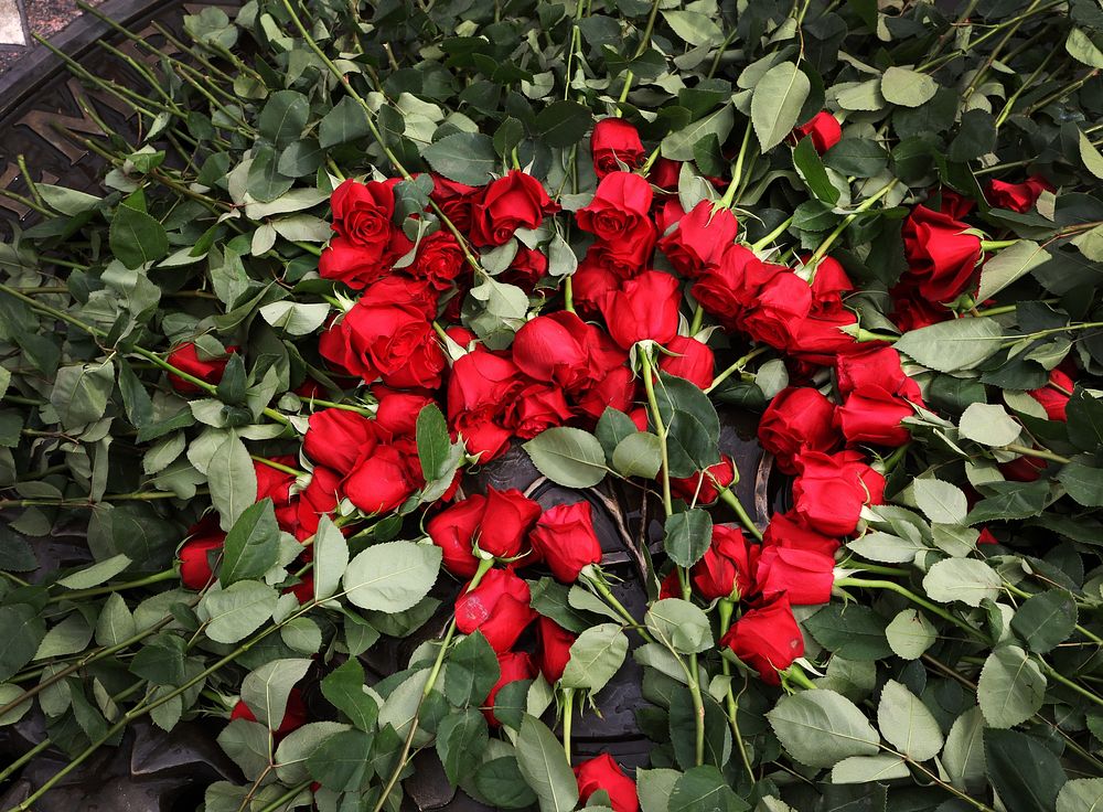 Roses rest neatly stacked at the center of the National Law Enforcement Officers Memorial during a wreath-laying ceremony…