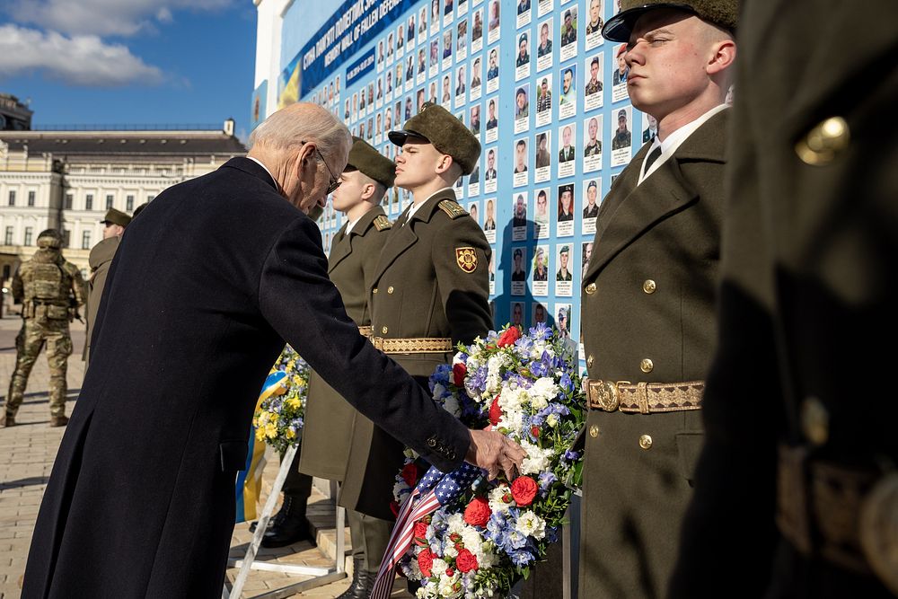 President Joe Biden touches a wreath, Monday, February 20, 2023, at the Wall of the Fallen at St. Michael’s Monastery in…