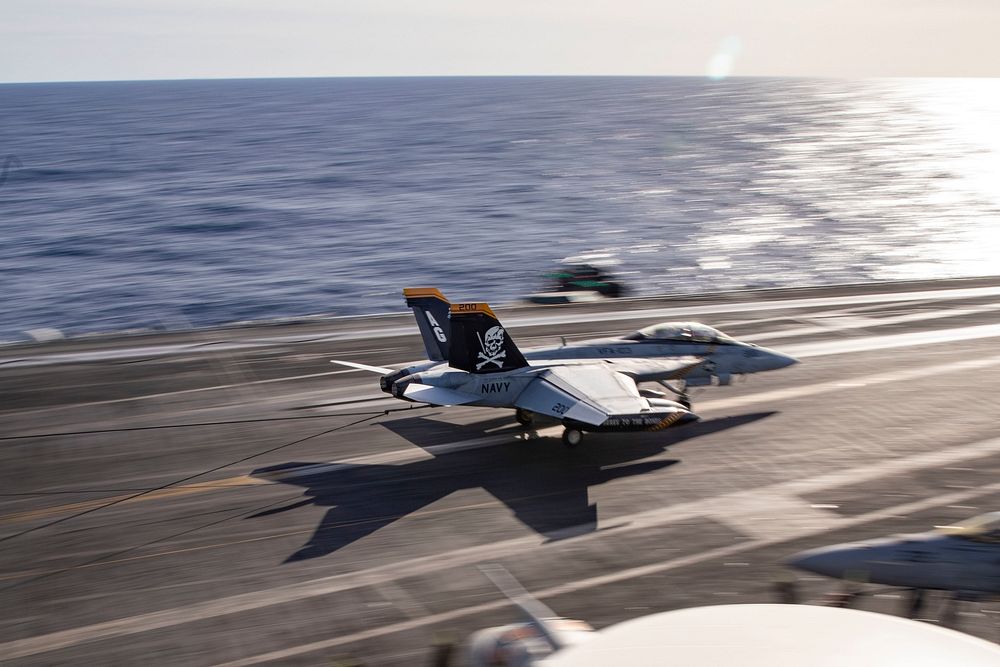 An F/A-18F Super Hornet aircraft, attached to Strike Fighter Squadron (VFA) 103, lands on the flight deck of the Nimitz…