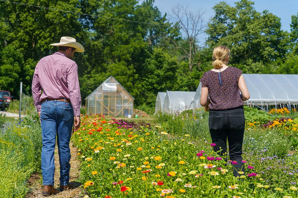 Kate Friesen (right) gives a tour of Singletree Flower Farm in Goshen, Indiana to Indiana NRCS district conservationist Wes…