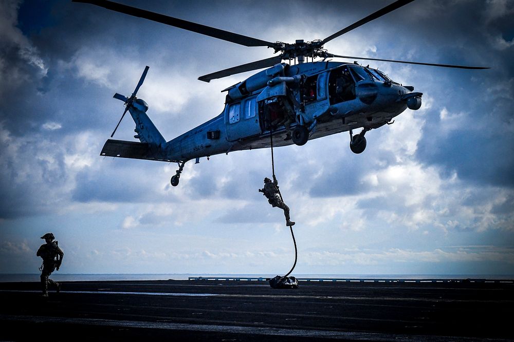 MEDITERRANEAN SEA (March 3, 2023) East-Coast-based U.S. Naval Special Warfare Operators (SEALs) fast-rope from an MH-60S…