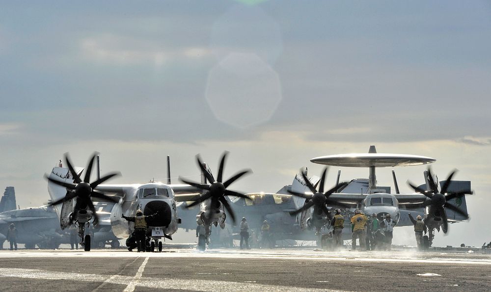 A C-2A Greyhound assigned to Fleet Logistics Support Squadron 40 and an E-2C Hawkeye assigned to Airborne Early Warning…