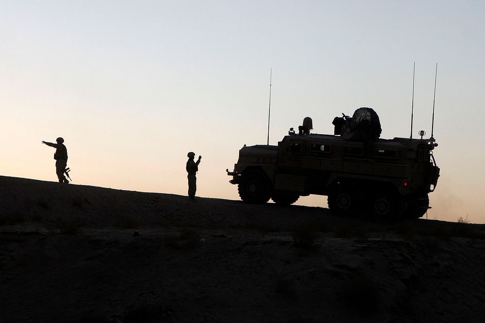 Marines of the Personal Security Detail, 1st Marine Logistics Group (Forward) (MLG FWD), guide their Mine Resistant, Ambush…