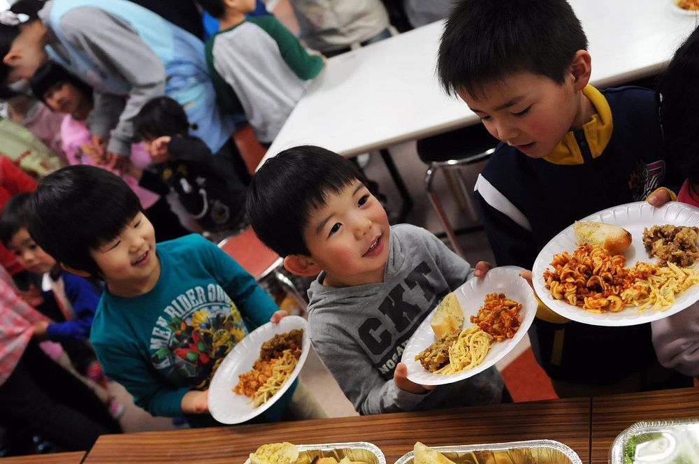 Children wait in line for a meal at the Biko-en Children's Care House in Shichinohe, Japan, during a community service…
