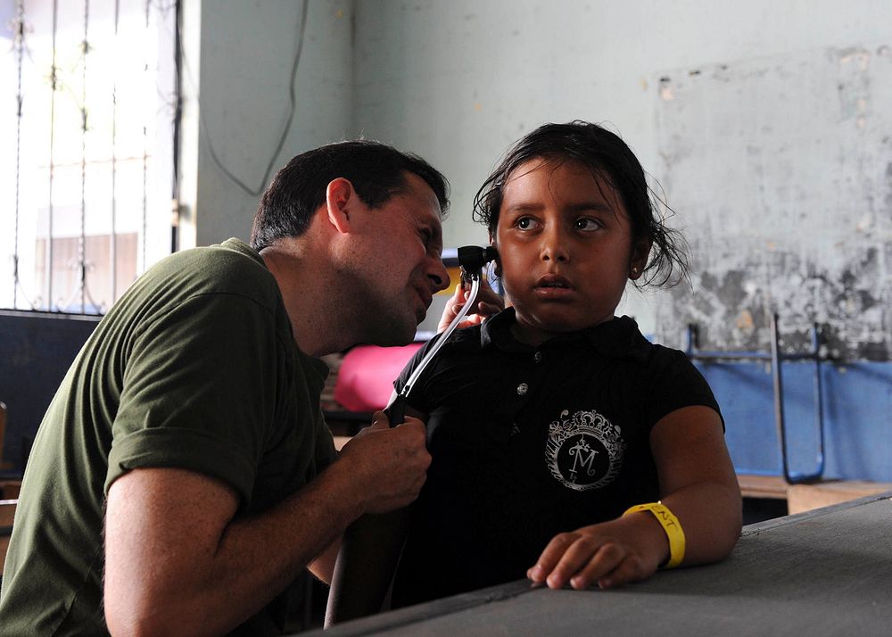 110630-F-ET173-099 - PUERTO SAN JOSE, Guatemala - (June 30, 2011) Peruvian Navy Cmdr. Mauricio Adrian checks a patient's…