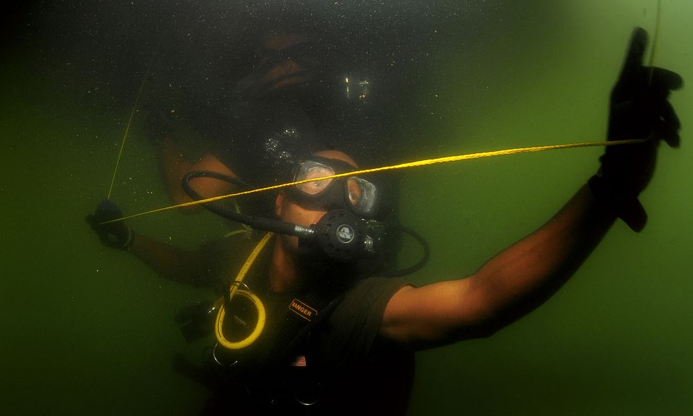 Royal Bahamas Defense Force diver Verron Charlton conducts a security sweep underneath of a Jamaican Defense Force Coast…