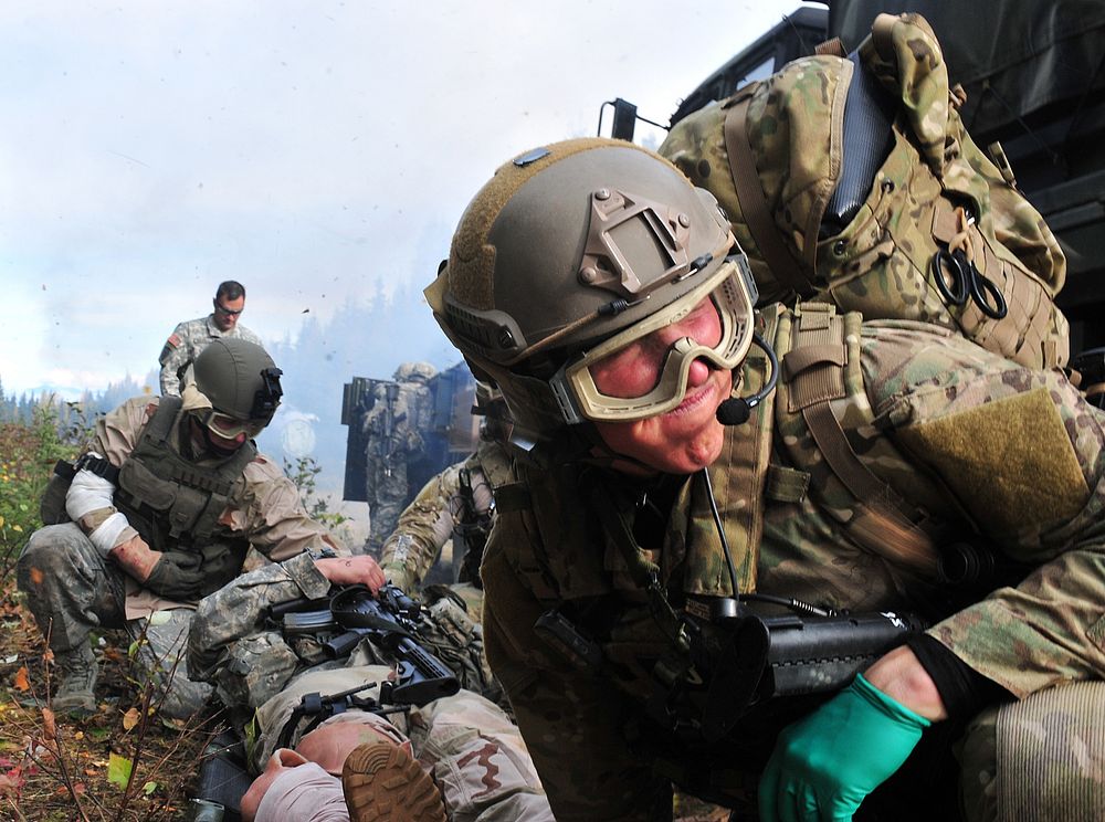 U.S. Air Force Staff Sgt. Bill Cenna, right, with the 212th Rescue Squadron pararescueman, prepares to move a patient on a…