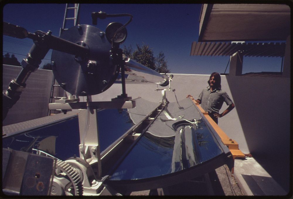 Prototype of a linear parabolic reflector used to gather the sun's energy and heat fluid in the center pipe to several…
