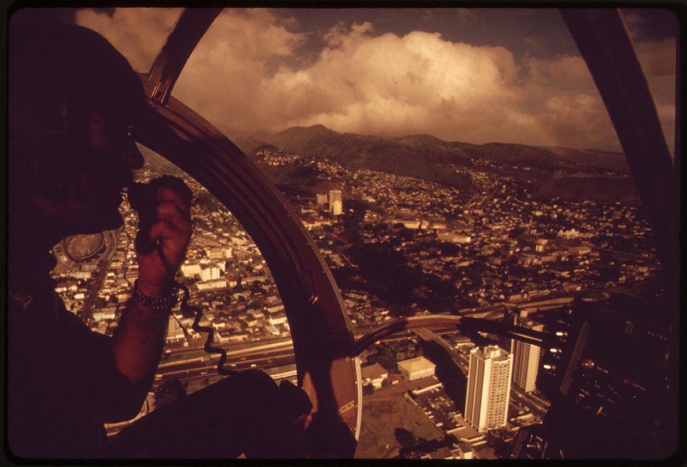 Helicopter pilot Irwin Malzman reports on rush hour traffic for radio station KGMB, October 1973. Photographer: O'Rear…