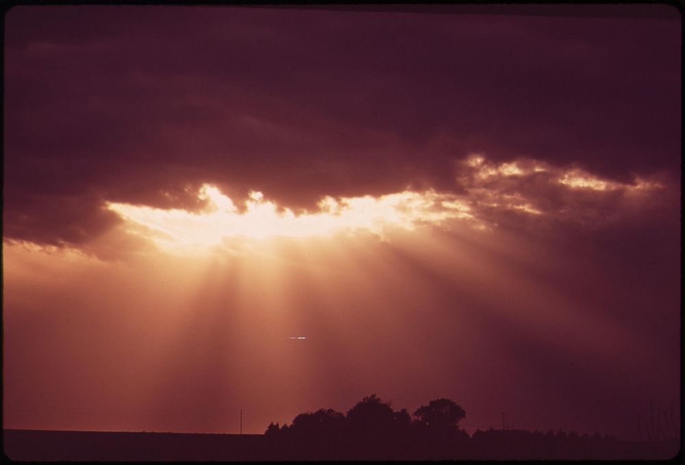 Sun rays through storm clouds over Grafton, in the farmlands west of Lincoln, May 1973. Photographer: O'Rear, Charles.…