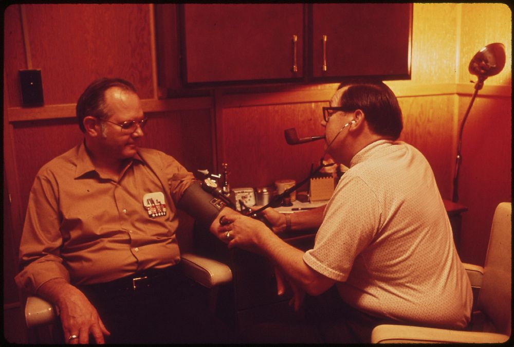 Dr. Charles Ashby of Geneva takes blood pressure of local businessman in his examining room, May 1973. Photographer: O'Rear…
