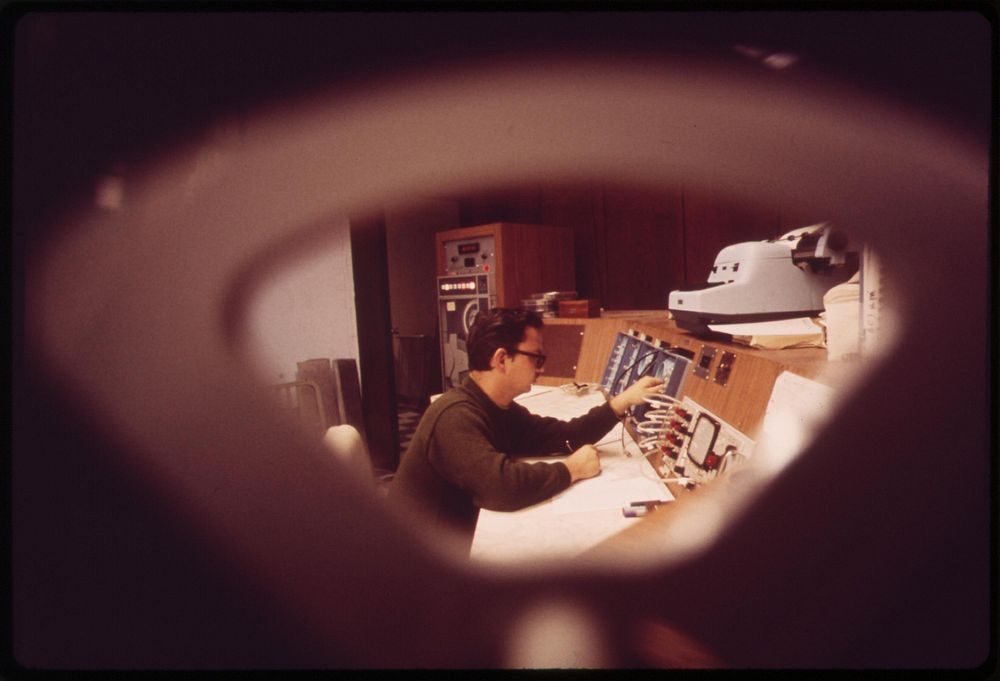 Technician at controls of "whole body counter" at EPA's National Environmental Research Center at Las Vegas, May 1972.…