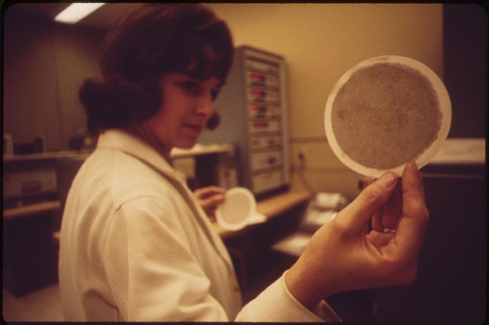 Laboratory at EPA's Las Vegas National Research Center technician holds up an air filter, May 1972. Photographer: O'Rear…