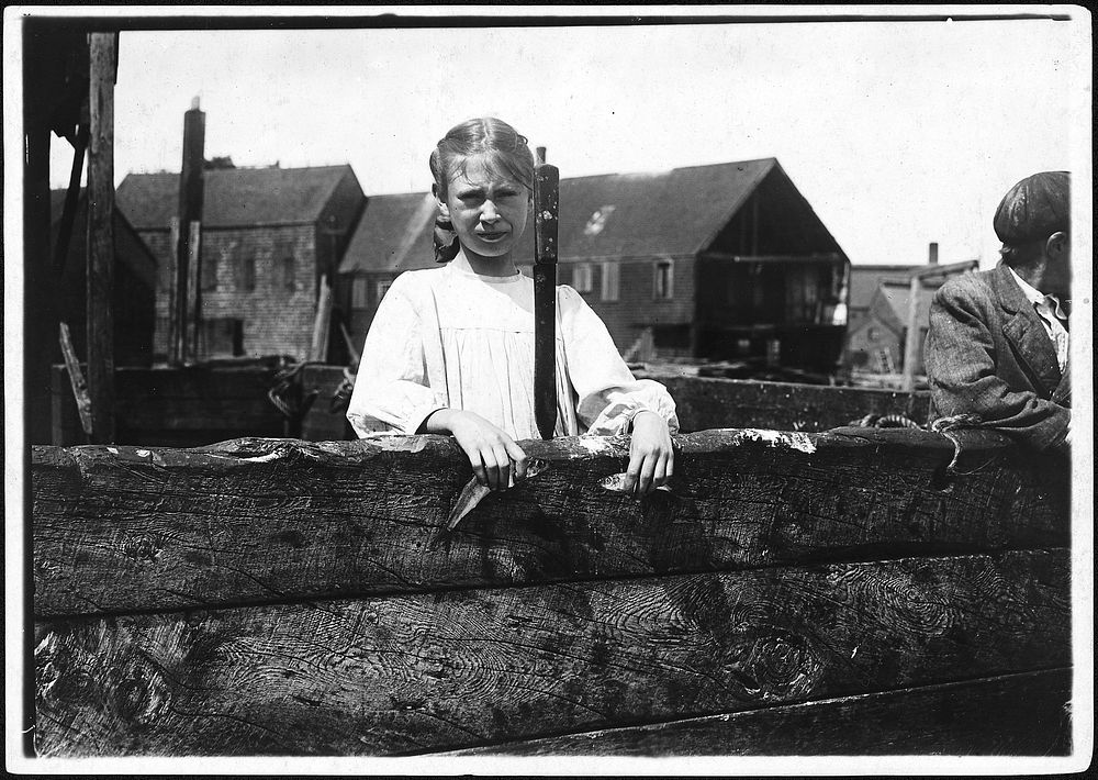 Minnie Thomas, 9 years old, showing the average size of the sardine knife as large as this. Eastport, Me, August 1911.…