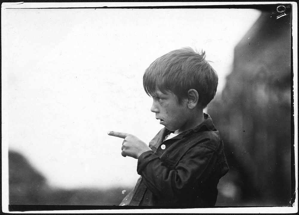 "I nearly cut my finger off, cutting sardines the other day." 7 year old Byron. Eastport, Me, August 1911. Photographer:…