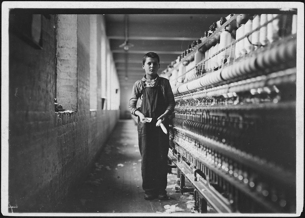 Tony Soccha, a young bobbin boy, been working there a year, November 1911. Photographer: Hine, Lewis. Original public domain…