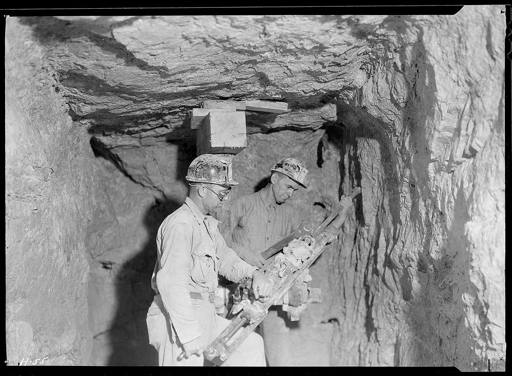 Arthur Roberts and Sam Mynatt drilling in lateral test shaft for examination of substrata at base of Norris Dam, October…