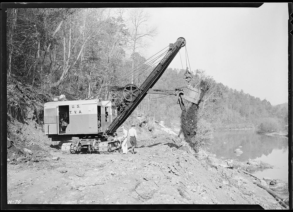 Making the dirt fly at Norris Dam site. A power shovel working on the roadway at the Dam, October 1933. Photographer: Hine…