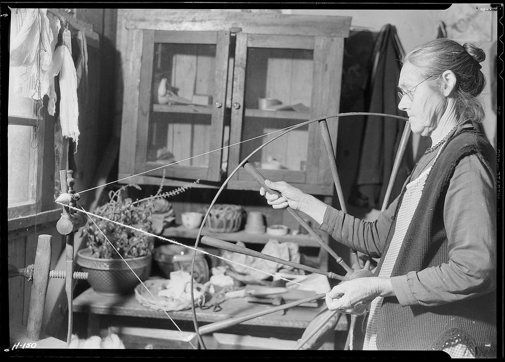 Another view of Mrs. James Watson spinning wool yarn in her cabin near Gatlinburg, Tennessee, November 1933. Photographer:…