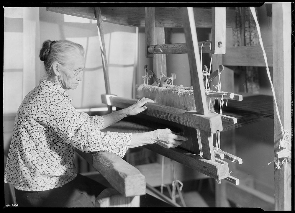 Another view of Aunt Lizzie Reagan weaving old-fashioned jean at the Pi Beta Phi school, November 1933. Photographer: Hine…