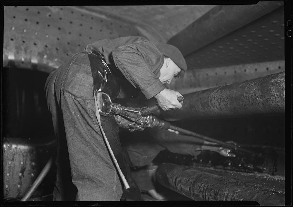 Railroad parts. Baldwin Locomotive Works. Boilermaker tapping for stay-bolts in boiler of a modern locomotive, March 1937.…