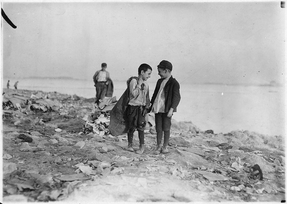 Boys picking over garbage on the dumps. Boston, Mass, October 1909. Photographer: Hine, Lewis. Original public domain image…
