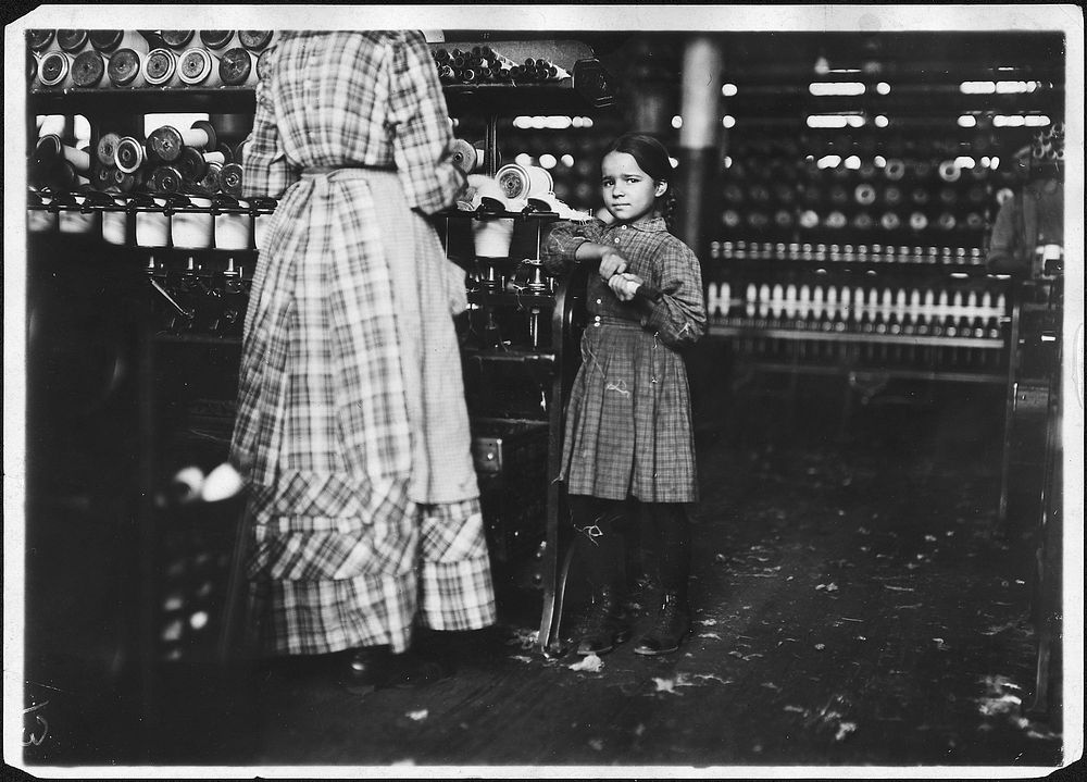 Little Fannie, 7 years old, 48 inches high, helps sister in Elk Cotton Mill, November 1910. Photographer: Hine, Lewis.…