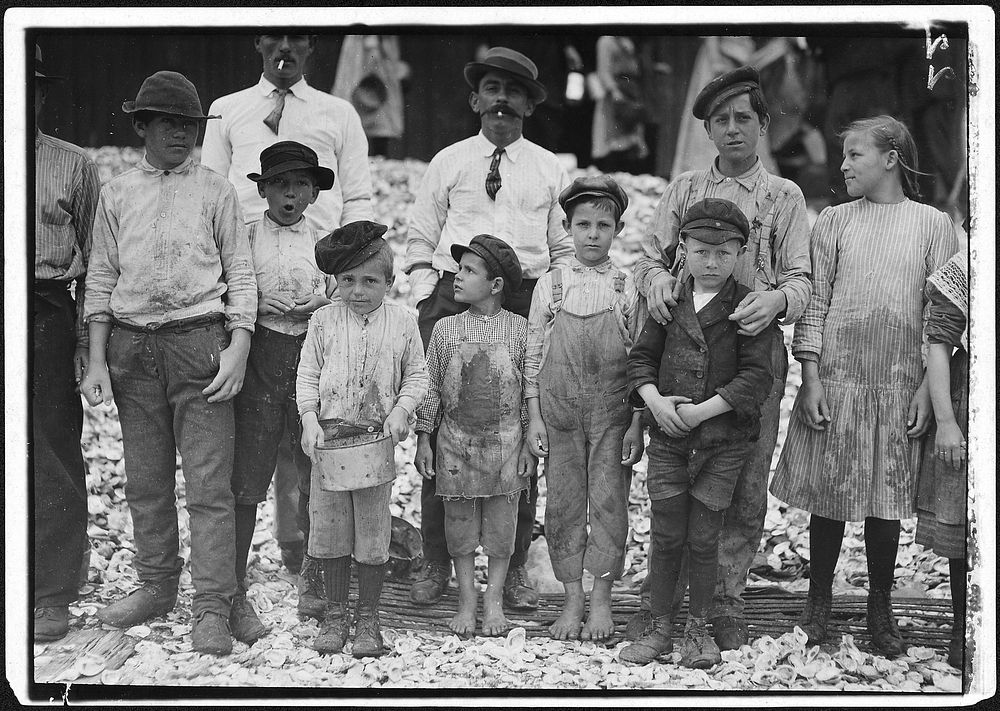 All these are shrimp pickers. Youngest in photo are 5 and 8 years old. Biloxi, Miss, February 1911. Photographer: Hine…